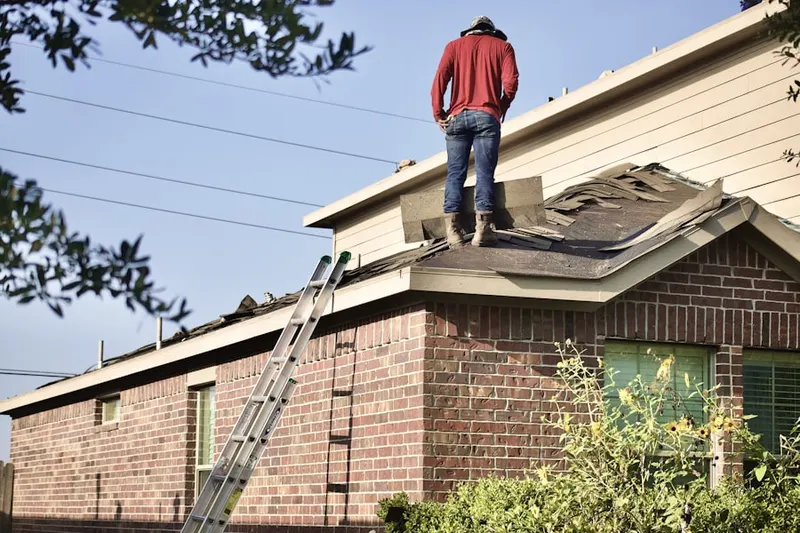 Professional roofer working on a residential roof in Saint Petersburg